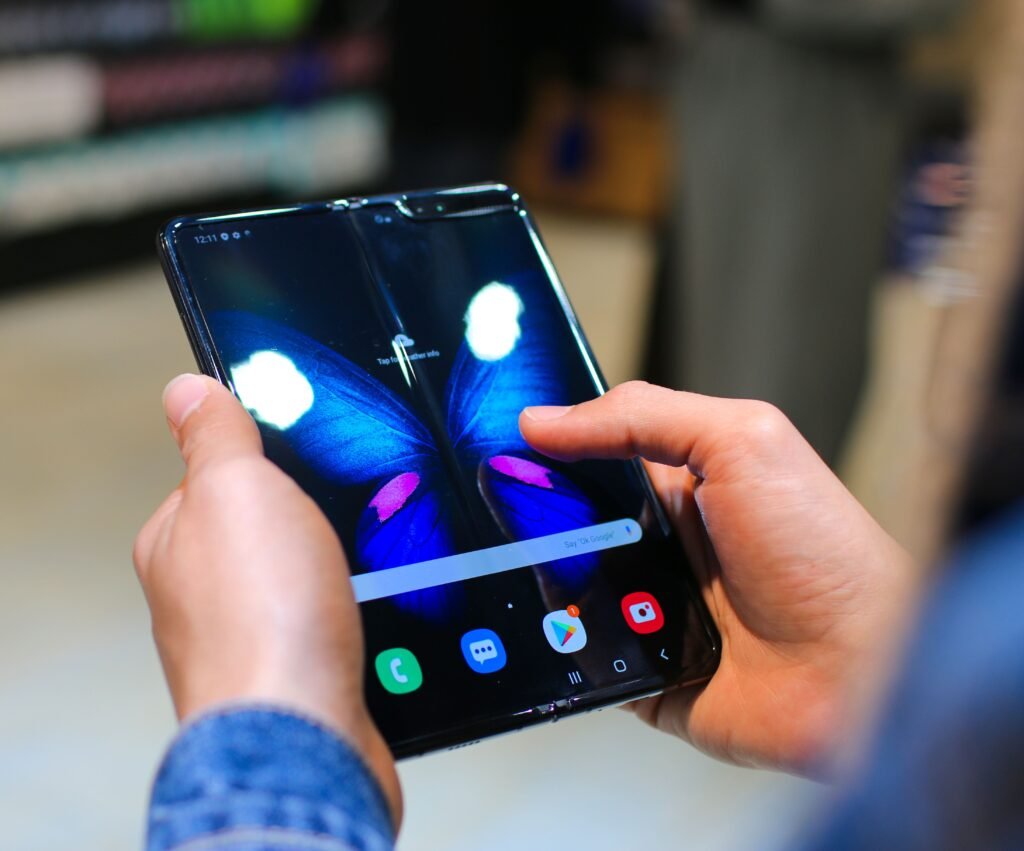 Vivo’s 8-Inch Foldable Has a 6,900mAh Battery. Europe Pays 2,199 Euros for It. Close-up of hands holding an unfolded book style foldable smartphone, the form factor used by the vivo X Fold6