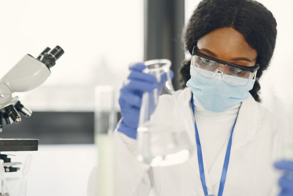 A Broken Test Tube Killed a Russian Lab Worker. The Official Cause of Death Keeps Changing. A laboratory worker in protective goggles and a face mask handling samples
