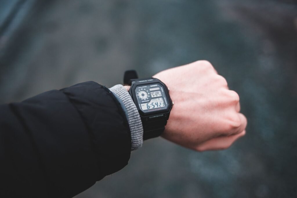 Person wearing a smartwatch with a blank black screen, illustrating the Pixel Watch battery drain bug