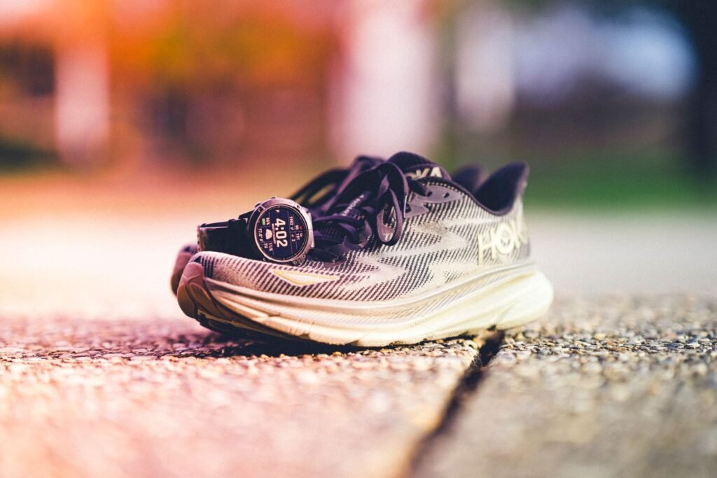 Polar’s 6.0.18 Update Adds Trend Graphs, a Custom Button and an 80% Charge Limit Runner's shoes and a sports smartwatch on a sunny day, illustrating the Polar 6.0.18 firmware update for running watches