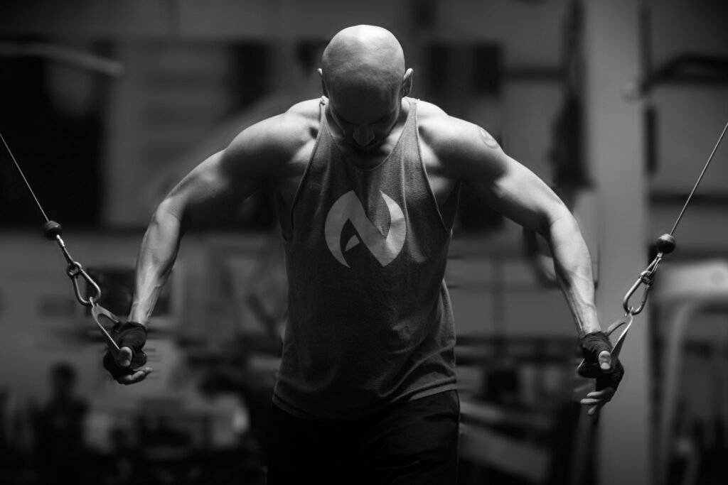 Man training in a gym, the kind of workout where an upper-arm heart rate sensor helps