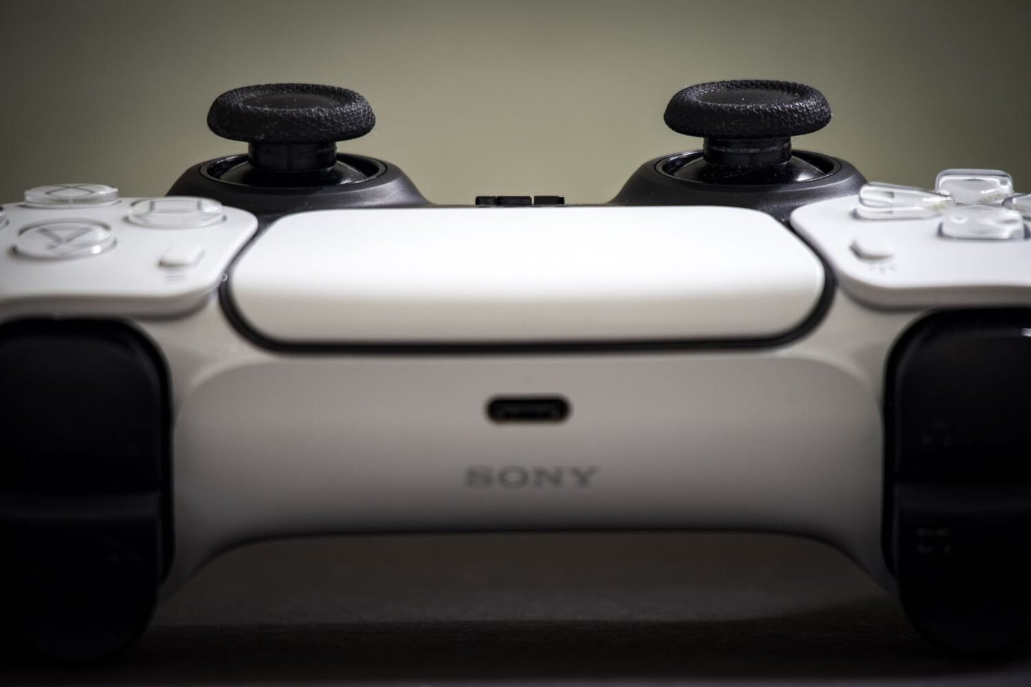 Close-up of a white PlayStation 5 DualSense controller