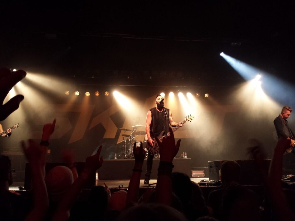 Instagram Kept Telling Everyone to Add Creed to Their Stories. Meta Says It Was Not Supposed To. A rock band playing on stage under bright spotlights with fans raising their hands in the crowd