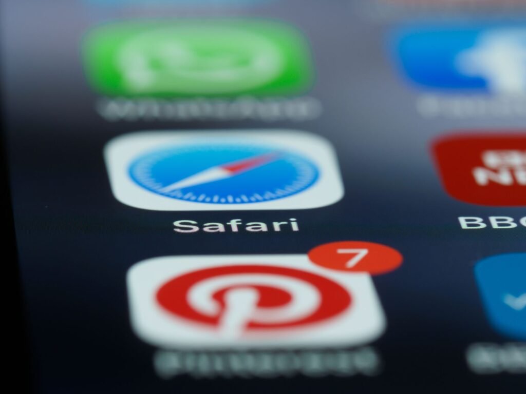 Close-up of a smartphone home screen showing the Safari app icon next to other apps