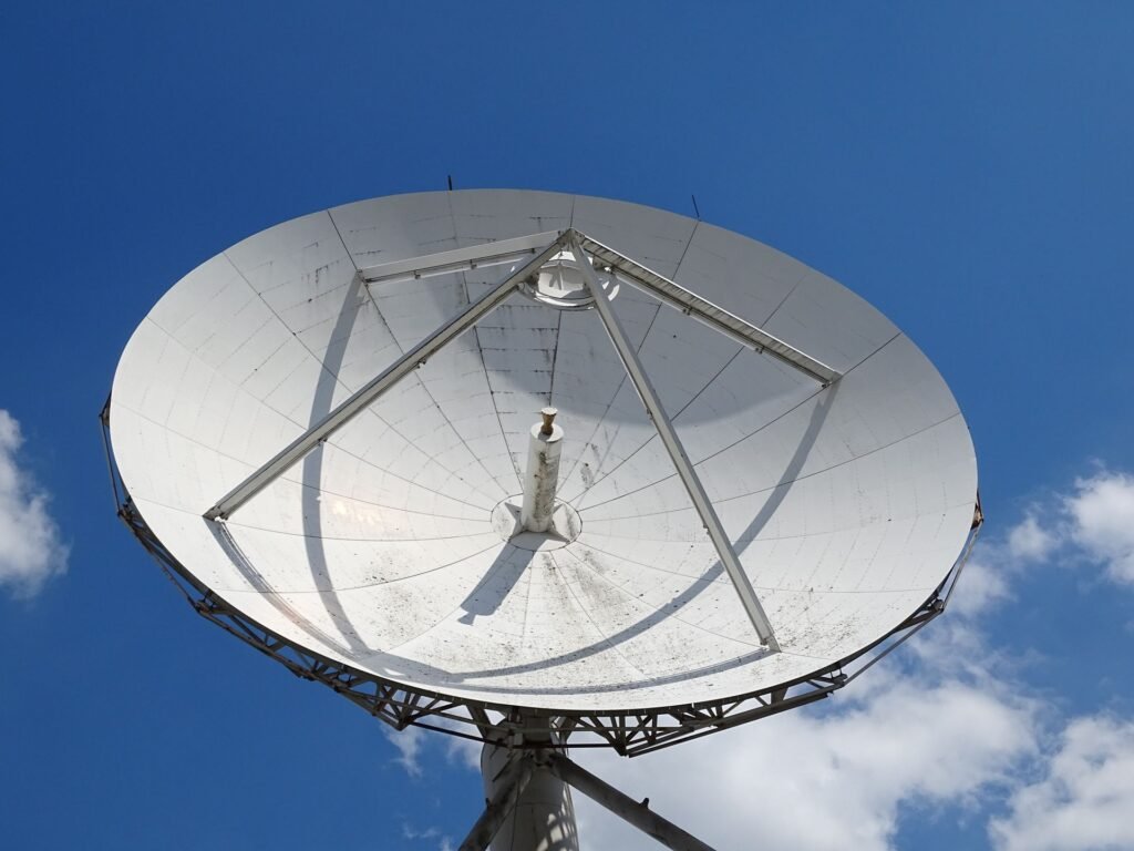 Starlink Held at 180 km/h in the EU. In Ukraine It Quits at 161. Low angle view of a large satellite dish against a blue sky with scattered clouds