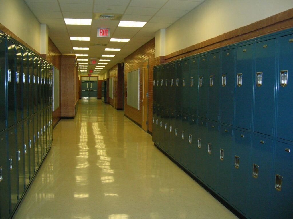 Someone Used Claude to Port Bully to Unreal Engine 5. Take-Two Has Sued Fans for Less. Empty high school hallway lined with lockers