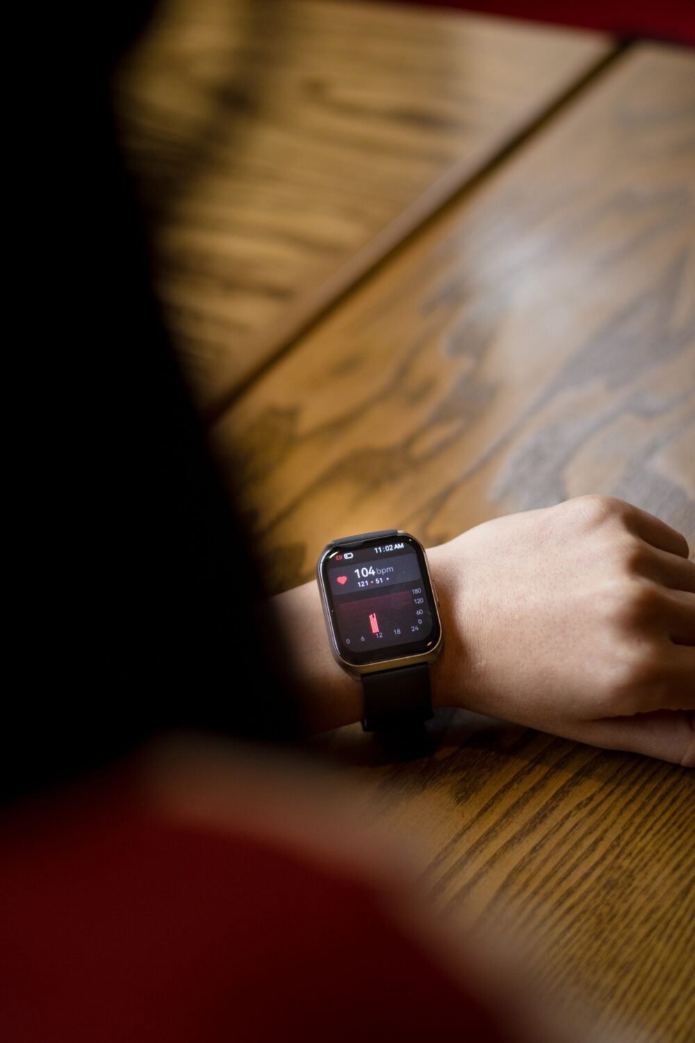 Person looking at a heart rate reading on a smartwatch worn on the wrist