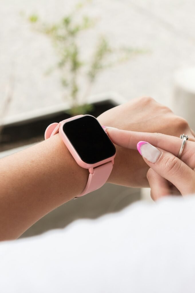 Woman wearing a pink smartwatch on her wrist